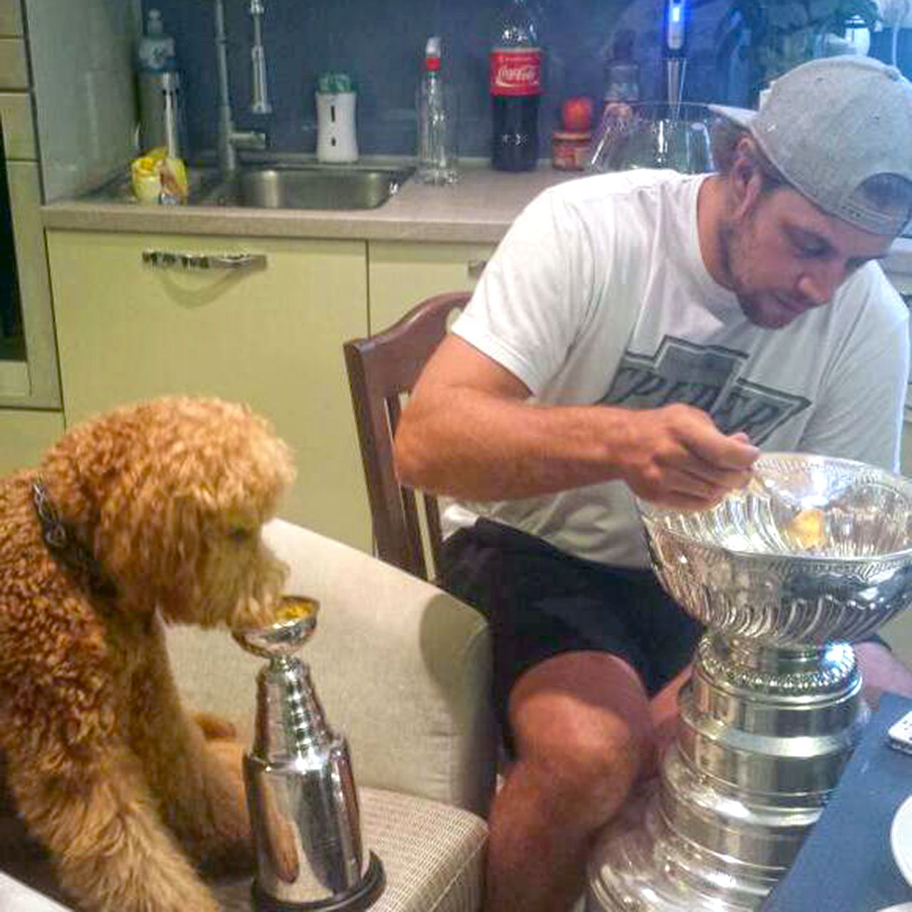 Gustl and Anze Kopitar chow down from Stanley Cup(s)