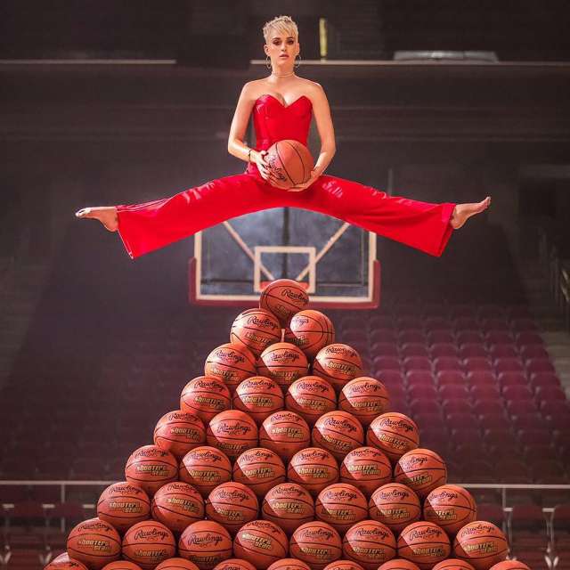 Katy Perry hovers over a basketball pyramid in promotion for her "Swish Swish" music video