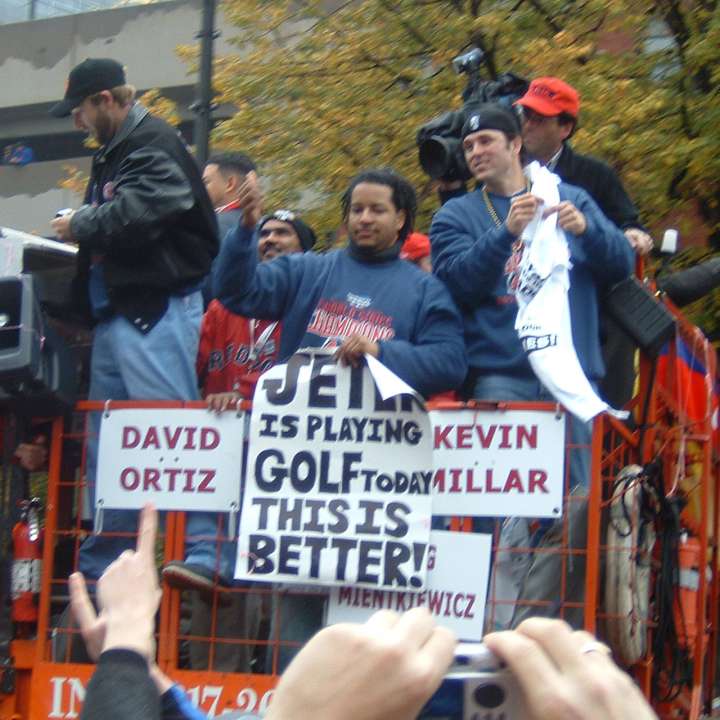Manny Ramirez holds a banner at the Red Sox World Series victory parade