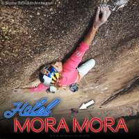 Sasha DiGiulian climbing high above the Hotel Mora Mora in Madagascar